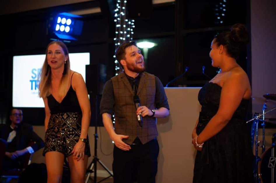 Performing corporate magic on stage for Sports Traider!